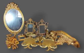 A pair of gilded metal picture frames together with other items to include an oval mirror and