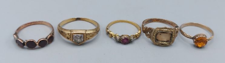 A 19th Century unmarked mourning ring, together with four other unmarked rings, 8.5gms