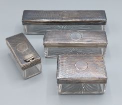 A set of four Victorian silver topped and glass dressing case boxes, London 1868