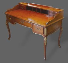 A hardwood writing desk, the super structure with four drawers above a moulded top and three drawers