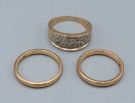 A 9ct gold diamond set dress ring together with two 9ct gold wedding bands, 9.3gms