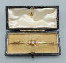 A 9ct gold bar brooch set with three Opals within a pierced setting