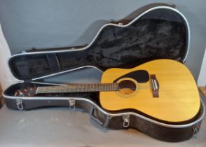 A Yamaha FX-310 acoustic guitar within hard carry case