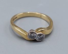 An 18ct gold Diamond crossover ring, set with two Diamonds, 3.3gms, ring size L