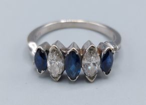 A 18ct gold Sapphire and diamond ring set with two Marquise cut diamonds with three similar Sapphire