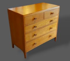 A 20th Century oak chest of two short and three long drawers with knob handles, raised upon turned