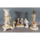 A German porcelain lamp base decorated with putti, together with a Goebels lamp and three