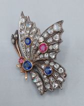 An Edwardian gold brooch in the form of a Butterfly set with three Sapphires, two Rubies and many