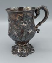 A Victorian silver mug of engraved and embossed form, London 1841, makers Charles Thomas Fox and