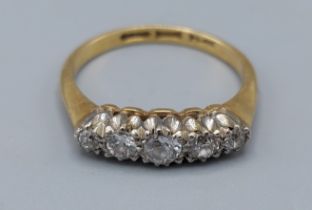 An 18ct gold five stone Diamond ring, claw set, 2.8gms, ring size M