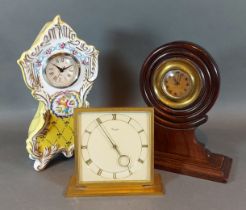 A brass table clock by Kienzle together with a Dresden table clock and another with turned wooden