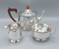 A George V silver three piece tea service comprising teapot, two handled sucrier and cream jug,