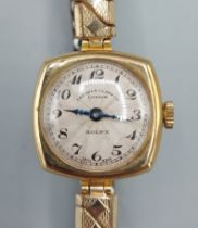 An 18ct gold cased ladies wristwatch by Rolex retailed by Alex Clark Co.