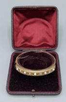 A Victorian gold bangle set with four Diamonds and five Pearls within fitted case, 16.6gms, 6cms x