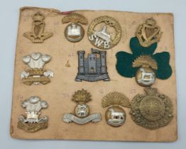 A collection of WWI cap badges, mainly Irish