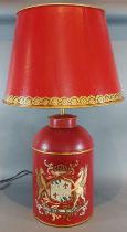 A Toleware table lamp, with gilded decoration on a red ground, complete with Toleware shade, 71cms