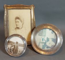 A Birmingham silver photograph frame, 17.5cms x 13cms together with two silver circular photograph