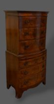 A Circa 1920's walnut bow front chest on chest, the moulded top with three long drawers above a