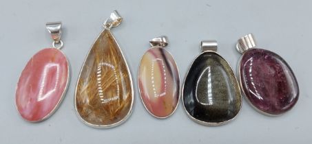 A 925 silver pendant mounted with a cabochon stone, together with four other silver pendants
