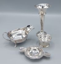 A Sheffield silver sauce jug together with a Birmingham silver tea strainer, 7ozs together with a