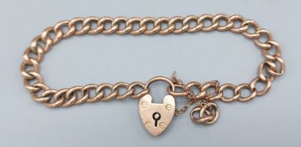 A 9ct gold curb link bracelet with padlock clasp, 9gms together