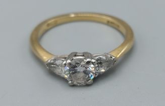 An 18ct gold three stone diamond ring, the central diamond approximately 0.50ct flanked by pear