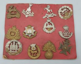 A collection of twelve WWI cap badges