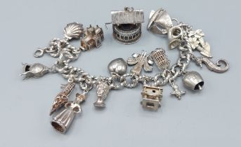 A silver charm bracelet with many charms