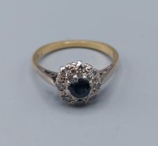 An 18ct gold Sapphire and Diamond cluster ring with a central Sapphire surrounded by Diamonds, 2.
