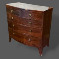 A 19th Century mahogany bow front chest of two short and three long drawers raised upon bracket