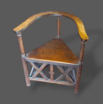 An Arts and Crafts Turners Chair, with octagonal and turned supports with shaped arms