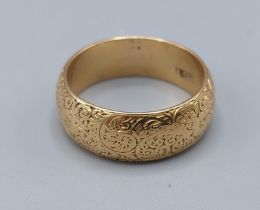 An 18ct gold engraved wedding band, 7.9gms, ring size N