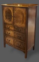 An Edwardian side cabinet, the moulded top above two inlaid panel doors and three long drawers