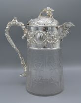 A silver plated and cut glass claret jug decorated with grape vine and figural spout, 26cms tall