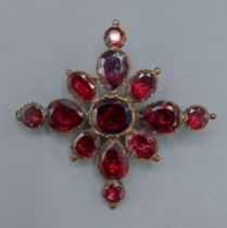 A 19th Century Garnet set brooch/pendant set with thirteen Garnets, 5cms x 4.5cms, 12.5gms
