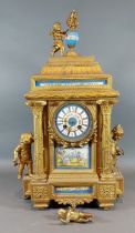 A 19th Century French gilded spelter and porcelain mantle clock, the painted dial with two train