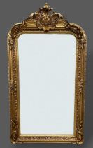 A gilded over mantle mirror with shaped cresting and foliate decorated frame, 155cms by 85cms