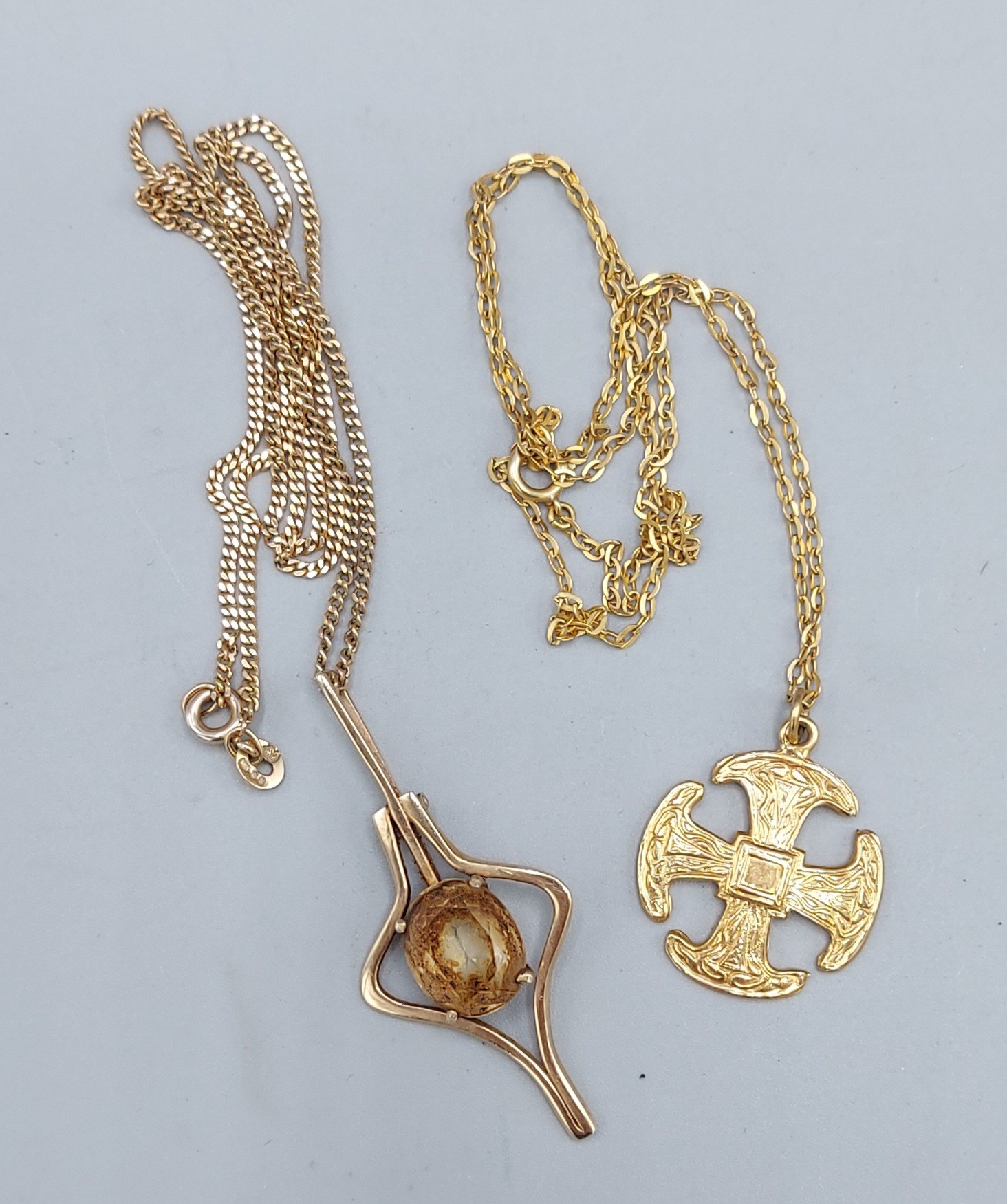 A 9ct gold pendant in the form of a cross together with a two 9ct gold neck chains and a yellow