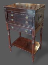 An Edwardian mahogany canteen cabinet on stand, the hinged top above two drawers raised upon