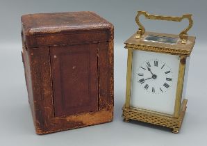 A French brass cased Carriage clock with travelling case