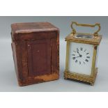 A French brass cased Carriage clock with travelling case