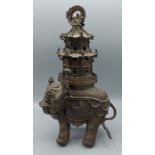 A Chinese bronze incense burner in the form of a elephant with pagoda, 30cms tall