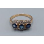 An 18ct gold Diamond and Sapphire triple cluster ring, 3.7gms, ring size O