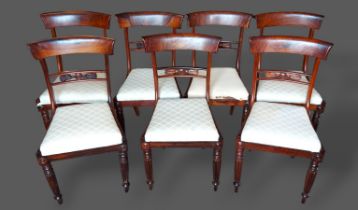 A set of seven William IV Rosewood dining chairs, each with a carved rail back above a drop in