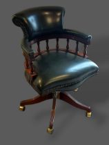 A mahogany and green leather captains swivel office desk chair