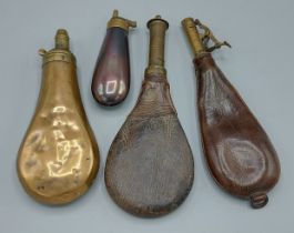 An early leather shot flask together with another similar and two metal powder flasks