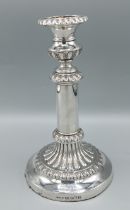 A George III silver candlestick with embossed decoration, Sheffield 1816, marker John & Thomas