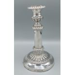 A George III silver candlestick with embossed decoration, Sheffield 1816, marker John & Thomas