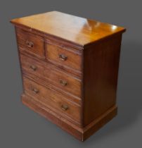 A late Victorian mahogany straight front chest of two short and two long drawers raised upon a