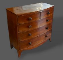 A 19th Century mahogany bow fronted chest of two short and three long drawers with knob handles